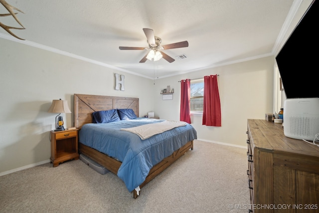 carpeted bedroom with ornamental molding and ceiling fan