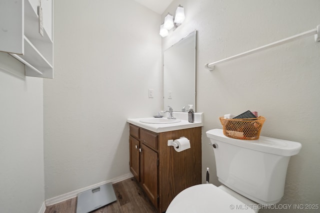 bathroom featuring vanity, toilet, and hardwood / wood-style floors