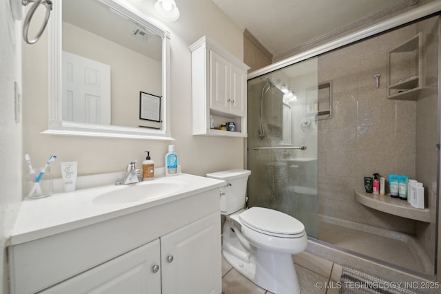 bathroom featuring vanity, a shower with shower door, and toilet