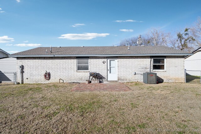 back of house with a yard and a patio