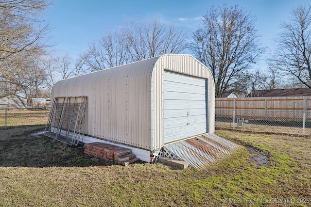 view of outdoor structure featuring a garage and a lawn