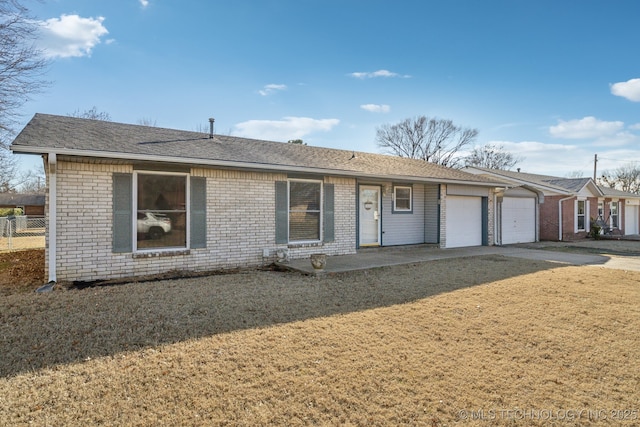 single story home with a garage and a front lawn