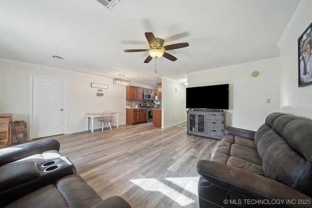 living room featuring ceiling fan, crown molding, and light hardwood / wood-style floors