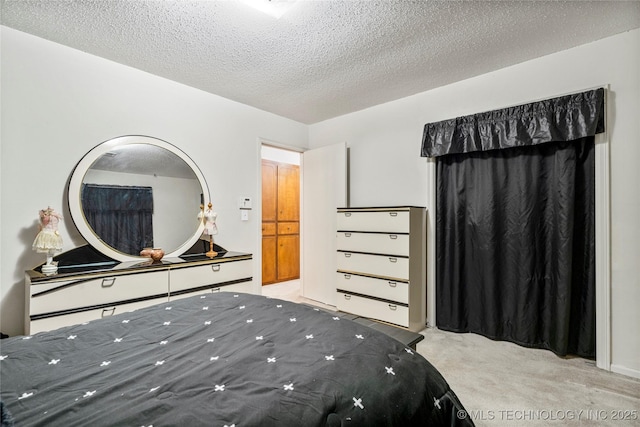 carpeted bedroom featuring a textured ceiling