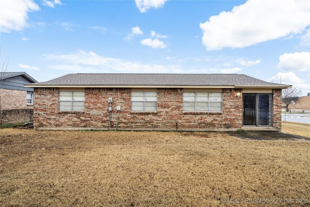 rear view of property with a lawn