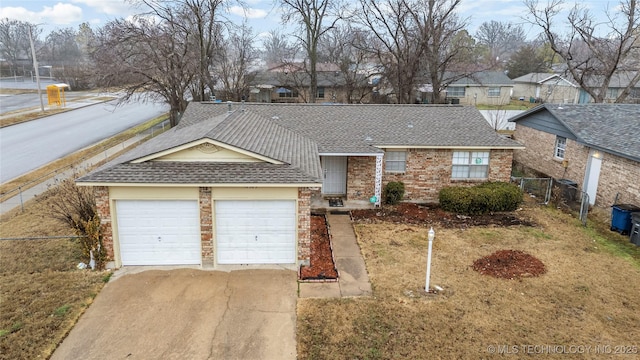 ranch-style home with a garage and a front yard