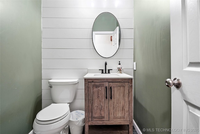 bathroom featuring vanity, hardwood / wood-style floors, and toilet