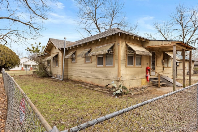 view of side of home featuring a yard