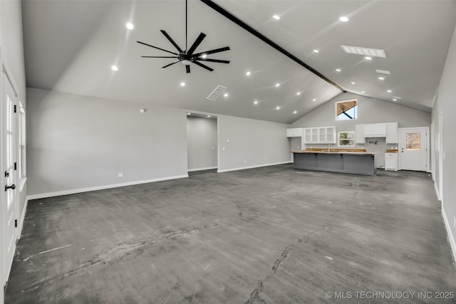 unfurnished living room featuring ceiling fan, sink, and high vaulted ceiling