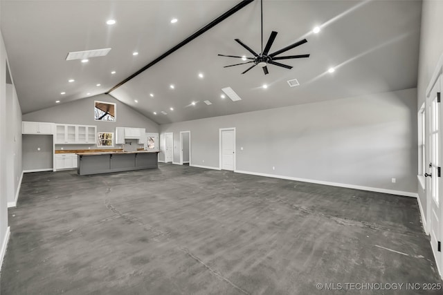 unfurnished living room featuring high vaulted ceiling and ceiling fan