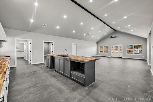 kitchen featuring sink, butcher block countertops, gray cabinetry, white cabinetry, and high vaulted ceiling