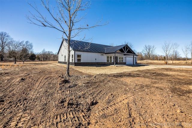 view of front of home featuring a rural view and a garage