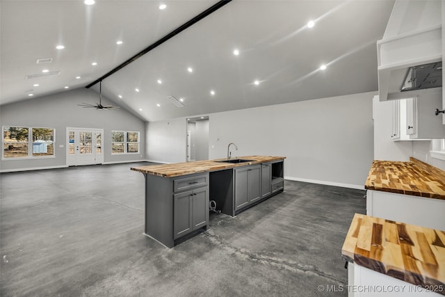 kitchen with gray cabinets, high vaulted ceiling, sink, wooden counters, and ceiling fan