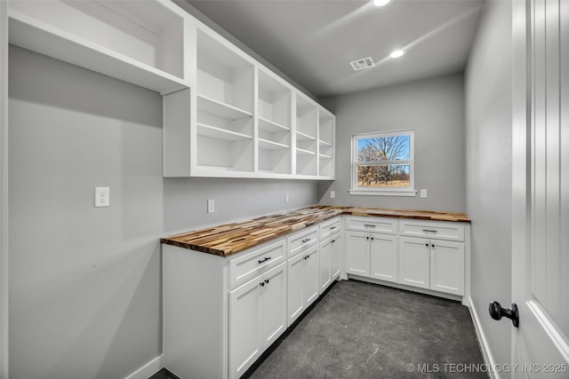 kitchen featuring wood counters and white cabinets