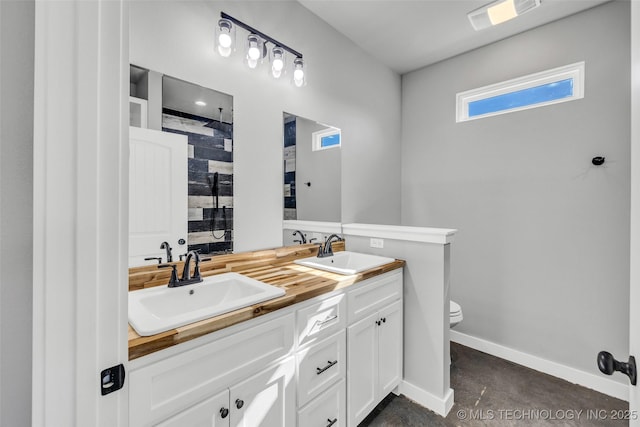 bathroom with vanity, a shower, and toilet