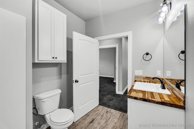 bathroom with vanity, hardwood / wood-style floors, and toilet