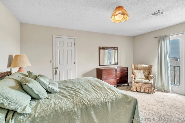 carpeted bedroom with a textured ceiling