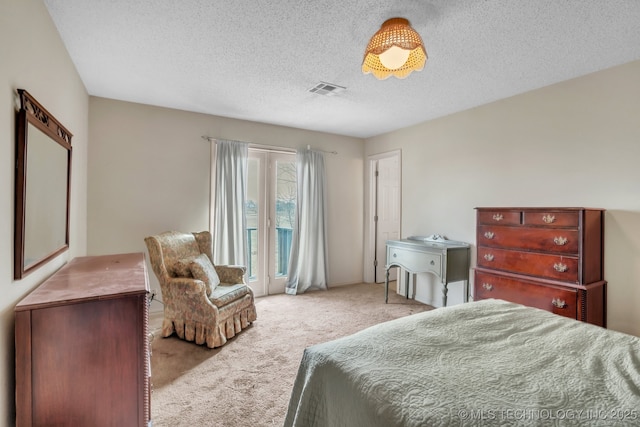 carpeted bedroom featuring a textured ceiling and access to outside