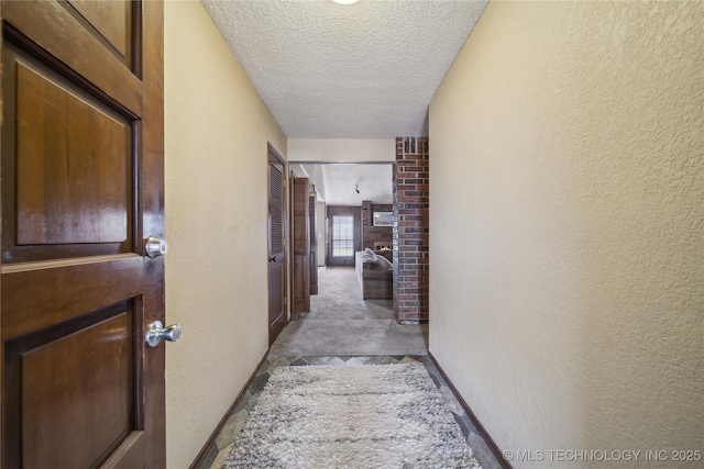 corridor featuring a textured ceiling