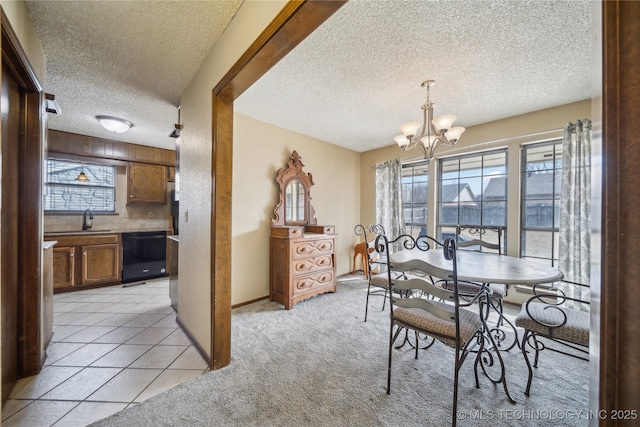 dining area featuring sink, light colored carpet, a textured ceiling, and a chandelier