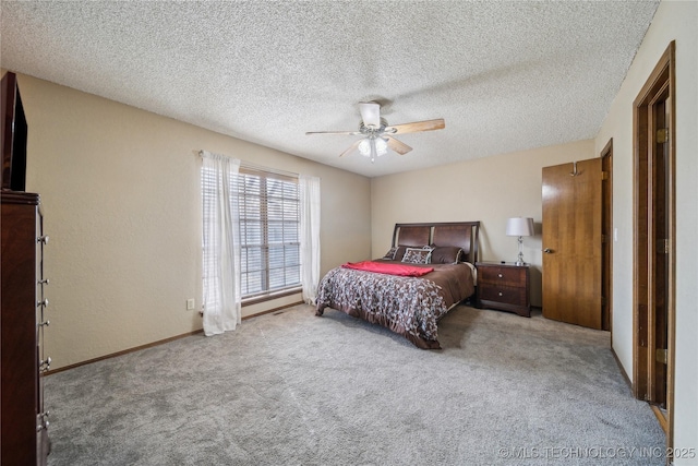 carpeted bedroom with ceiling fan and a textured ceiling