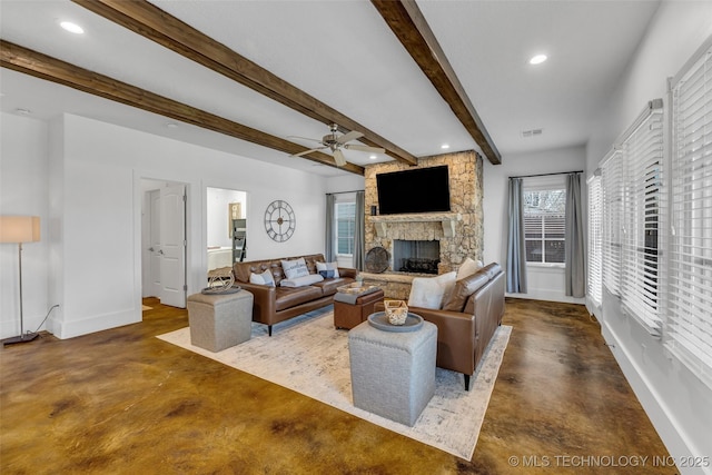 living room with a stone fireplace, beamed ceiling, and ceiling fan