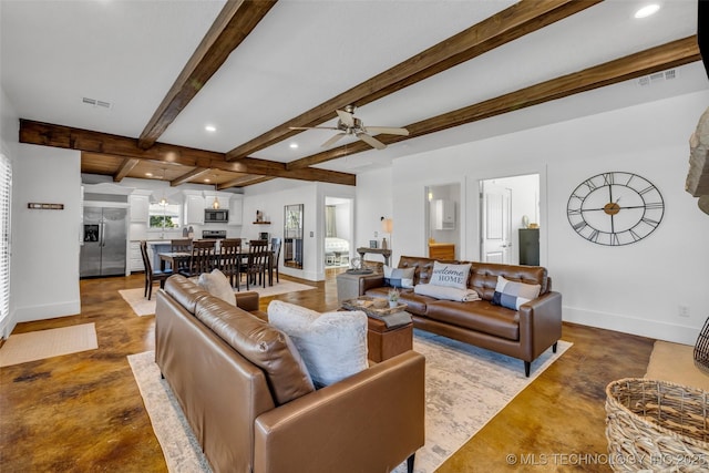 living room with ceiling fan, concrete flooring, and beamed ceiling