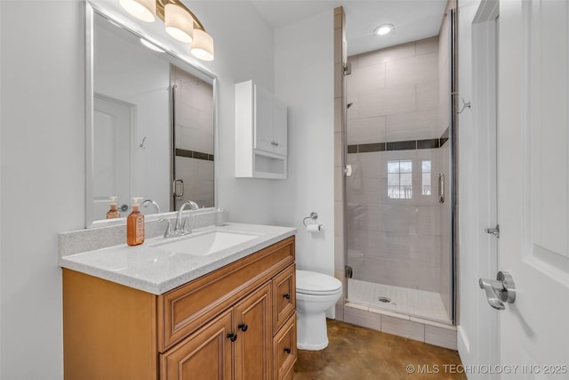 bathroom featuring vanity, toilet, and walk in shower