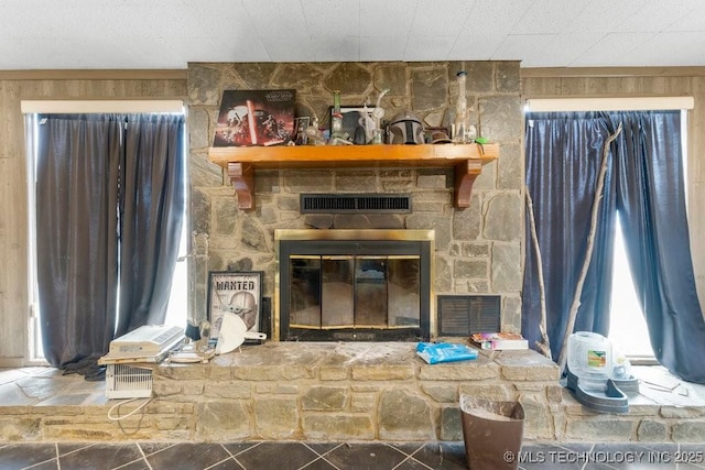 living room featuring a stone fireplace