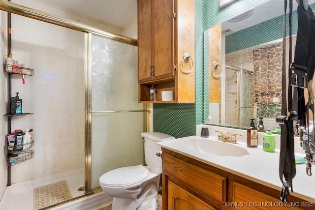 bathroom featuring walk in shower, vanity, and toilet