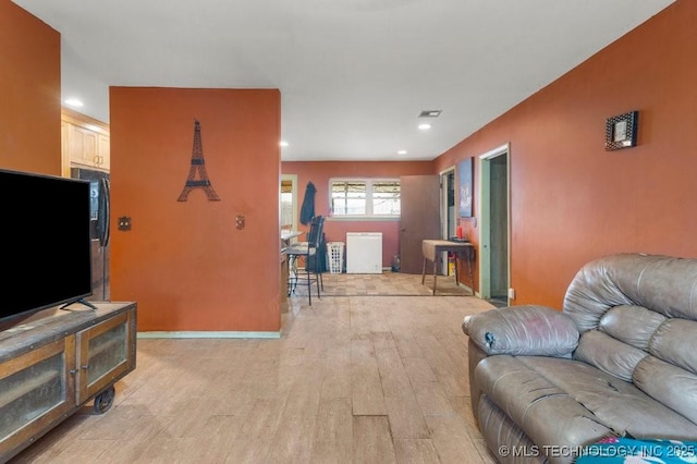 living room with light hardwood / wood-style flooring