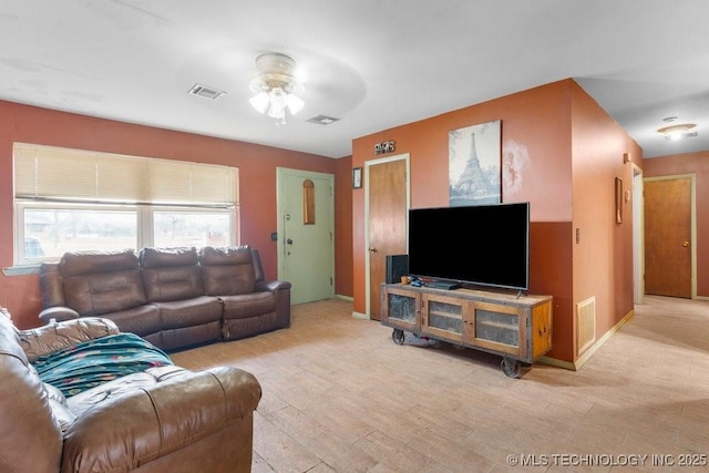 living room with ceiling fan and light hardwood / wood-style flooring