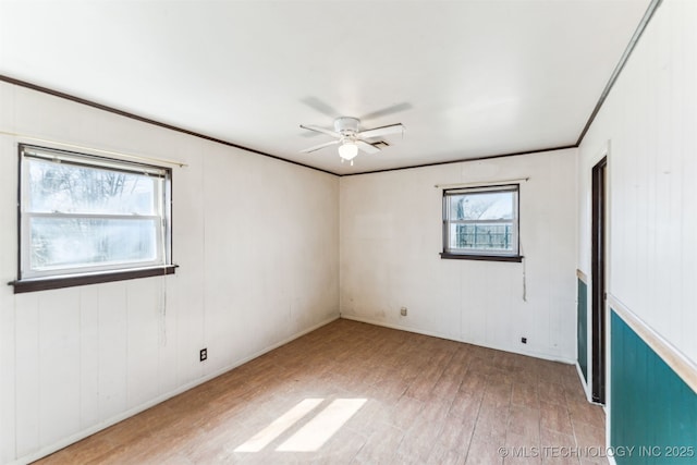 unfurnished room featuring crown molding, a ceiling fan, and wood finished floors