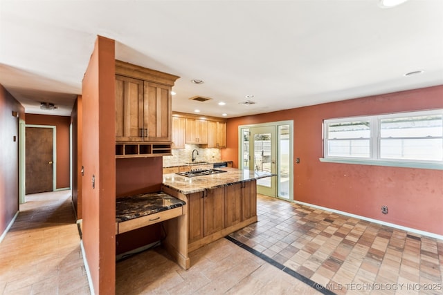 kitchen with visible vents, backsplash, baseboards, light stone counters, and recessed lighting