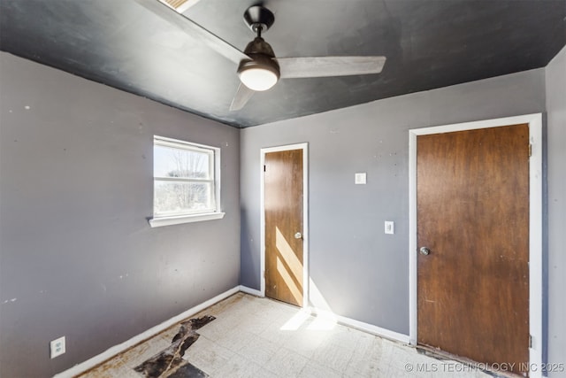 unfurnished bedroom featuring tile patterned floors, ceiling fan, and baseboards