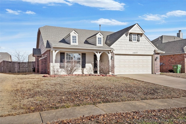 view of front facade featuring a porch, a garage, and a front lawn