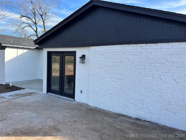 entrance to property featuring french doors and a patio area