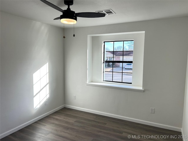 unfurnished room with ceiling fan and dark hardwood / wood-style flooring