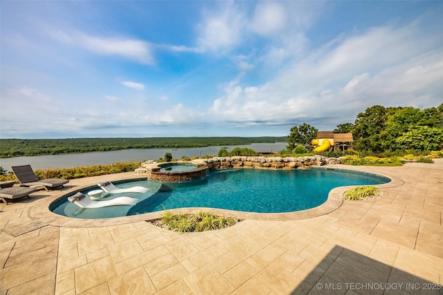 view of pool with an in ground hot tub, a water view, and a patio area