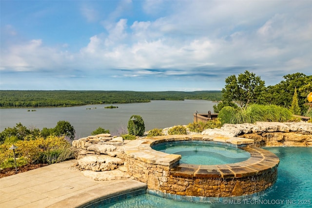 view of pool featuring an in ground hot tub and a water view