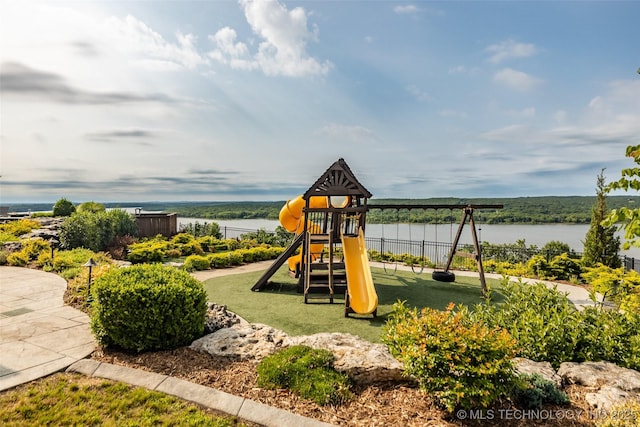 view of playground with a water view