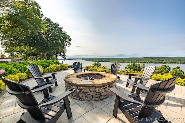 view of patio featuring a water view and a fire pit