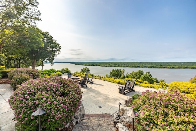 view of patio / terrace featuring a water view and an outdoor fire pit