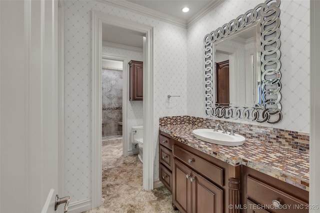 bathroom featuring crown molding, vanity, and toilet