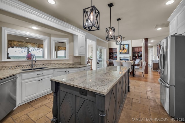 kitchen with white cabinetry, a kitchen island, and appliances with stainless steel finishes