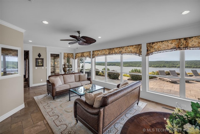 living room with ornamental molding, a water view, and ceiling fan