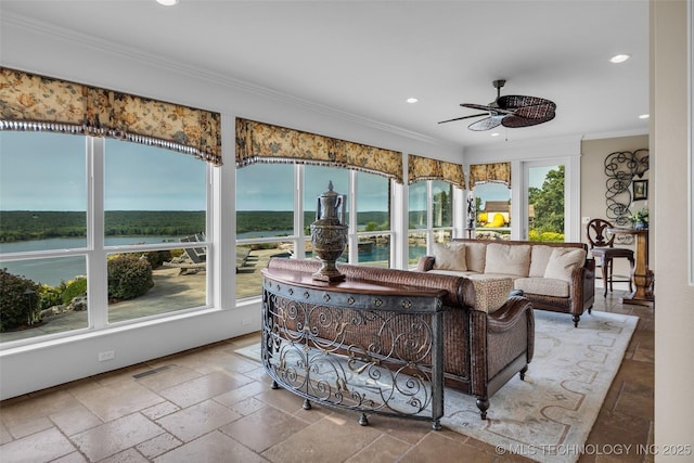 sunroom featuring a water view and ceiling fan