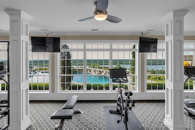 workout area featuring ornamental molding, ceiling fan, and ornate columns