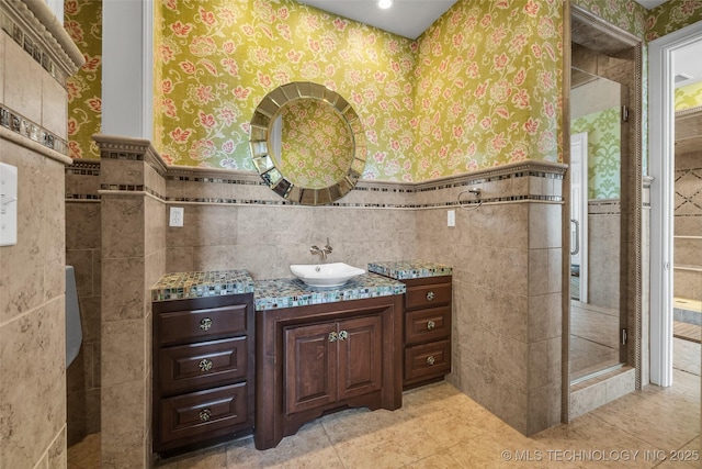 bathroom with tile walls and vanity