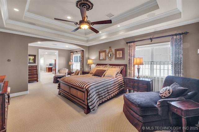 carpeted bedroom with a tray ceiling